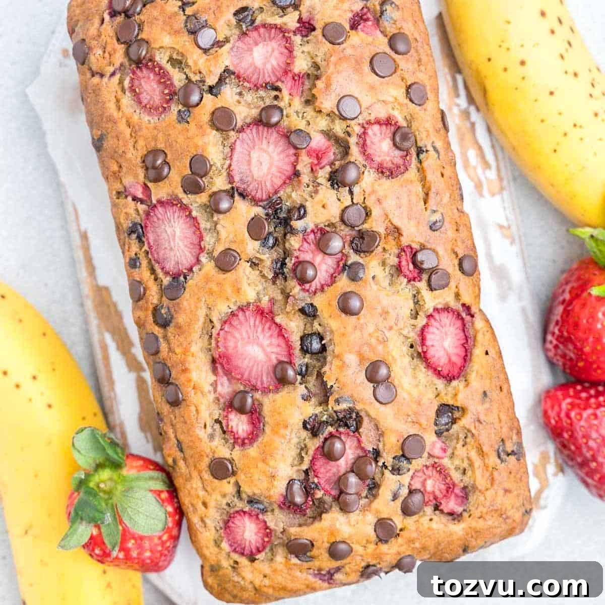 Strawberry Banana Bread Recipe: Moist Loaf with Fresh Fruit 7 banana bread unsliced on a flat surface.