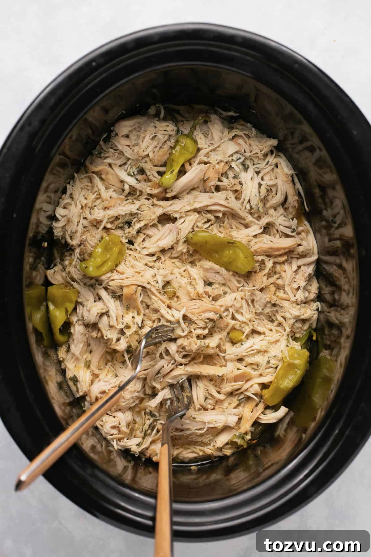 Mississippi Chicken: 3 Flavorful Variations 5 a crock pot filled with Mississippi chicken and pepperoncini peppers