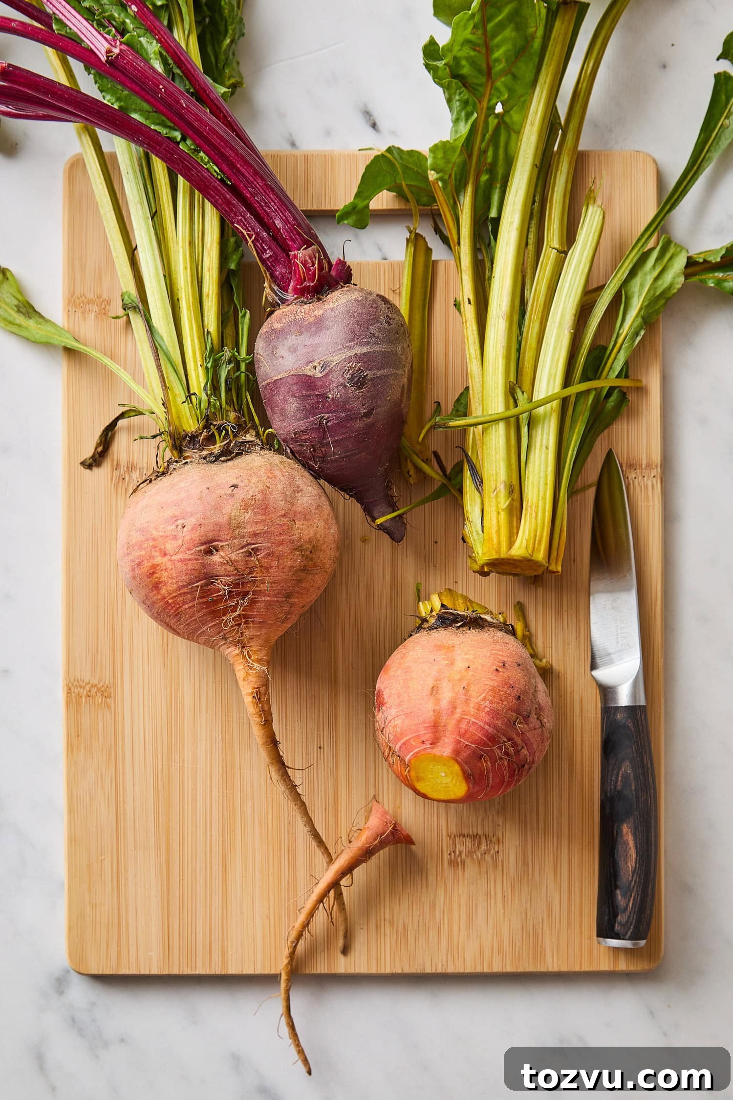 Grilled Steak with Roasted Beet and Goat Cheese Salad 7 Wooden cutting board with beets being prepared for roasting.