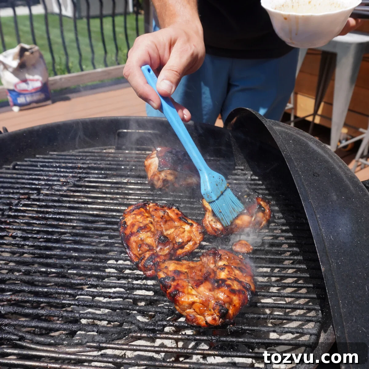 brushing grilled chicken with the best marinade.