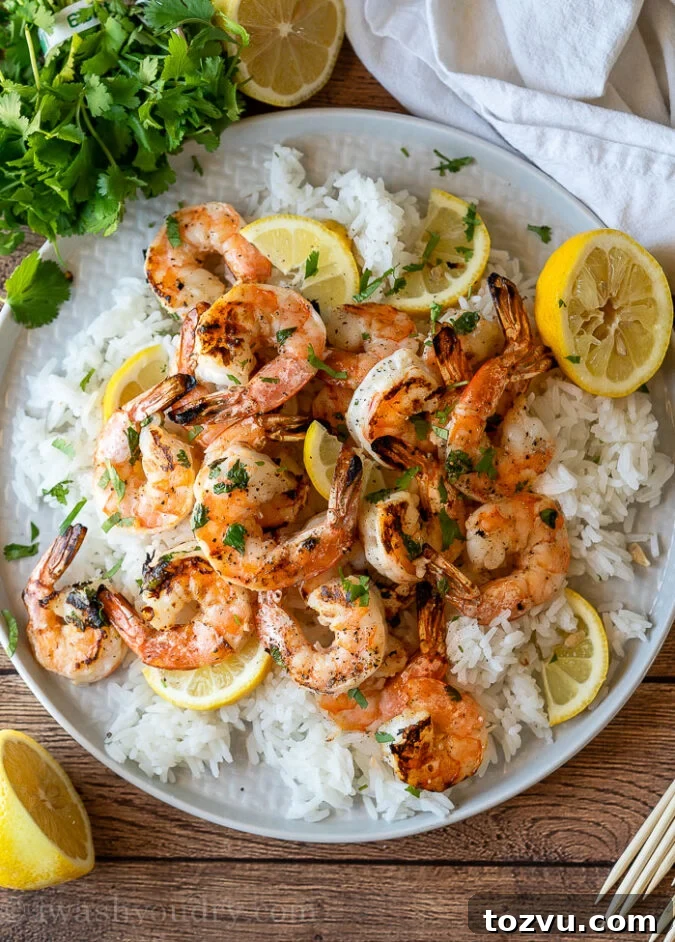 This Grilled Lemon Cilantro Shrimp Recipe is perfectly seasoned shrimp that are grilled up in minutes for a light and fresh Summer dinner.