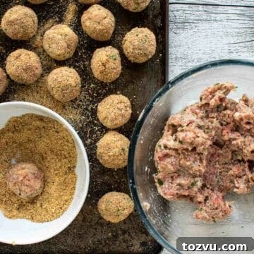 Crispy Fried Meatballs with Garlic Dipping Sauce 6 Meatballs mixture in a glass bowl, some meatballs rolled and coated in breadcrumbs.