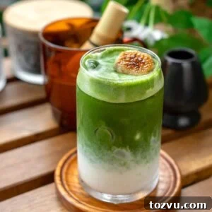 Creamy Banana Matcha Latte Recipe 13 matcha layered over blended banana milk with a banana garnish
