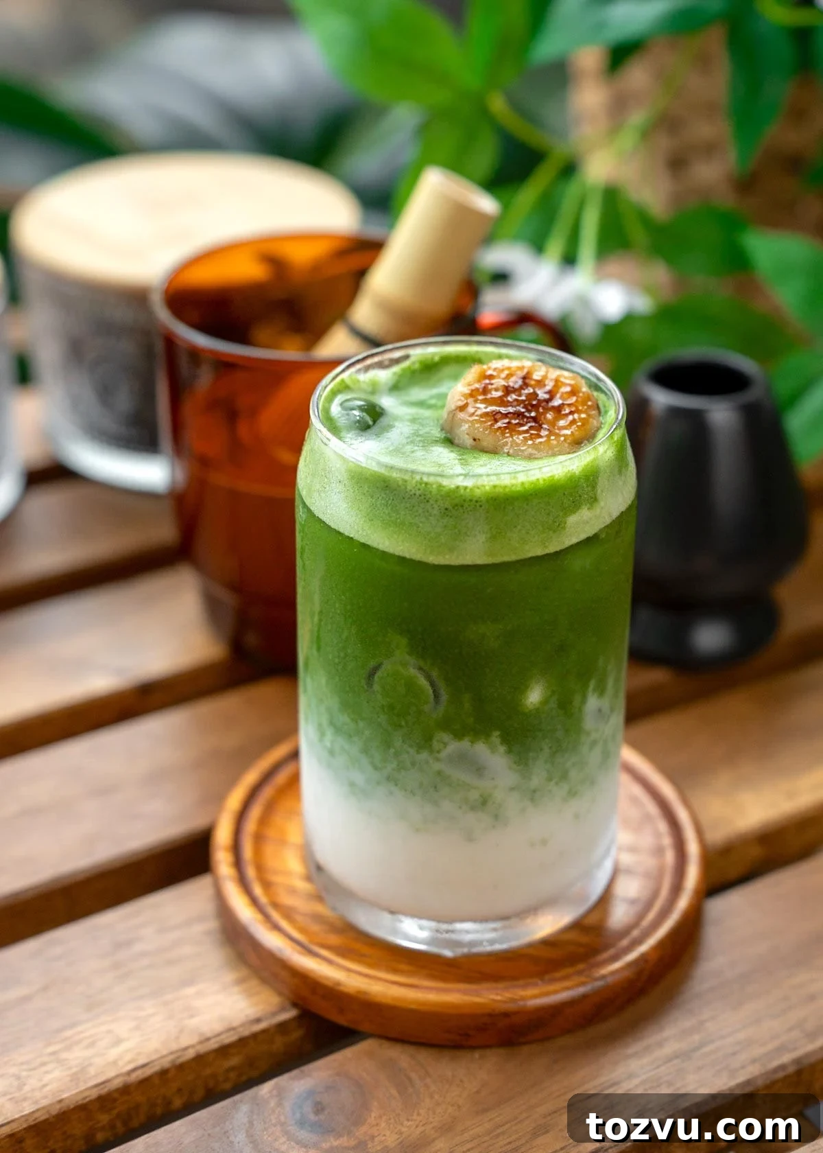 Creamy Banana Matcha Latte Recipe 10 matcha layered over blended banana milk with a banana garnish