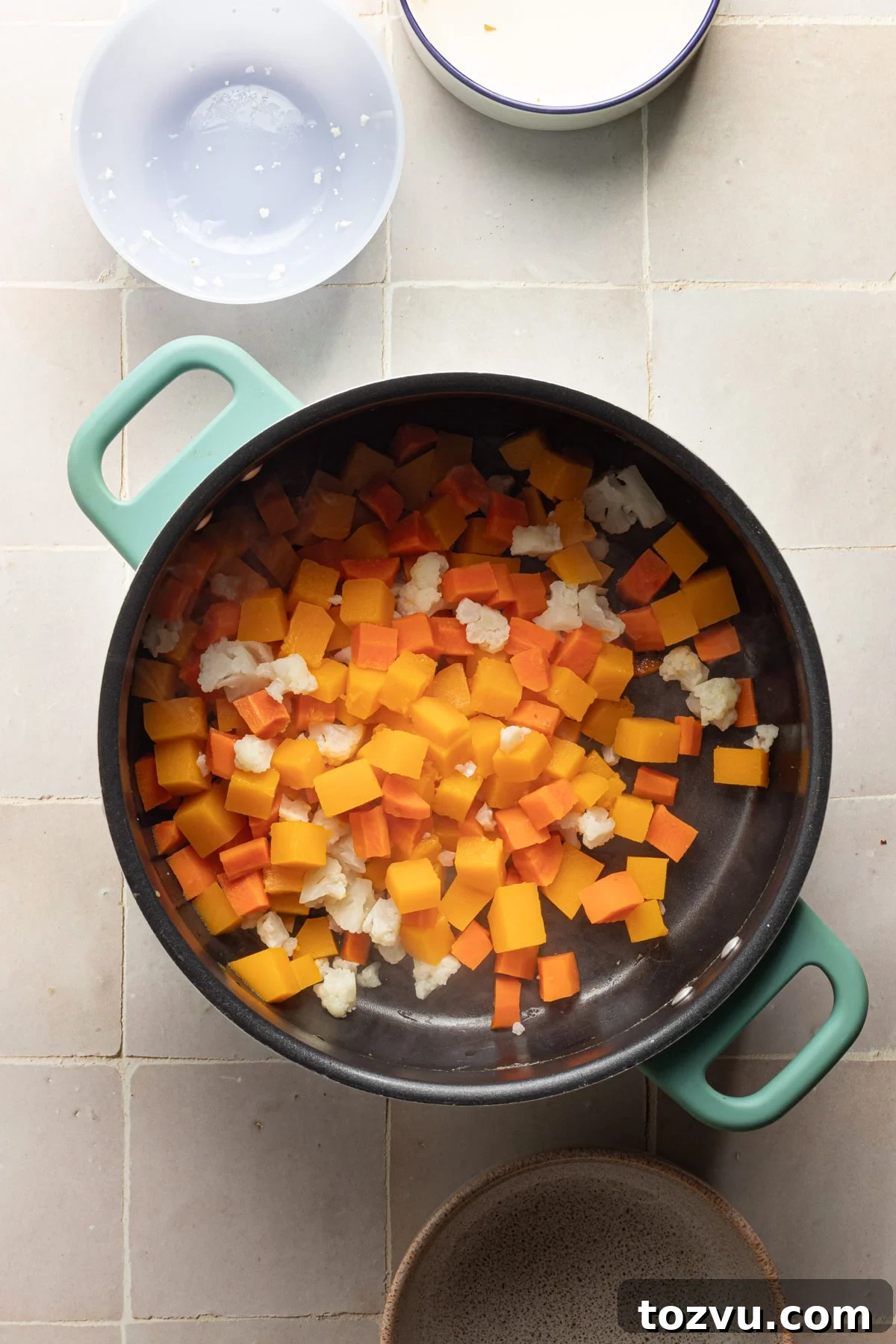 Creamy Hidden Vegetable Mac and Cheese Recipe 6 Butternut squash, cauliflower and carrots being cooked in a pot with water.