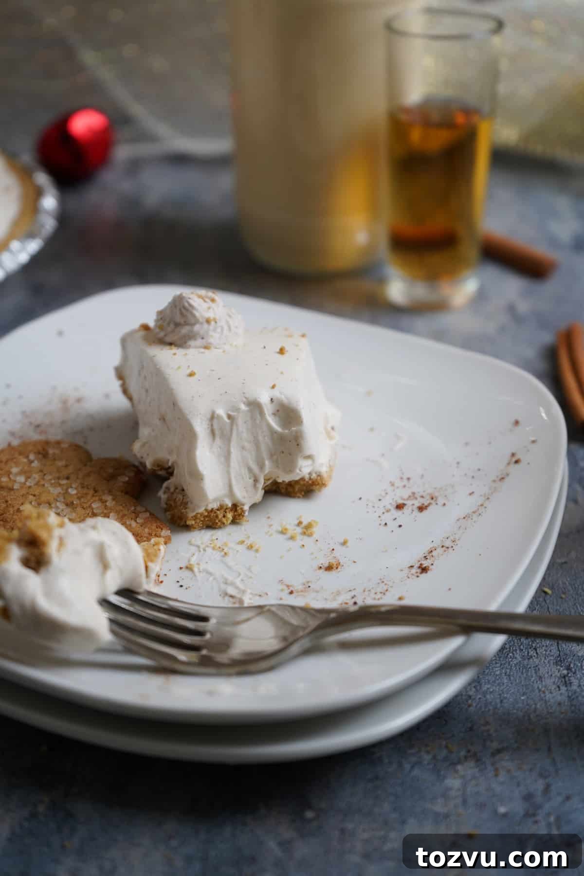 No-Bake Eggnog Cheesecake with a Boozy Twist 8 eggnog cheesecake with bite missing.