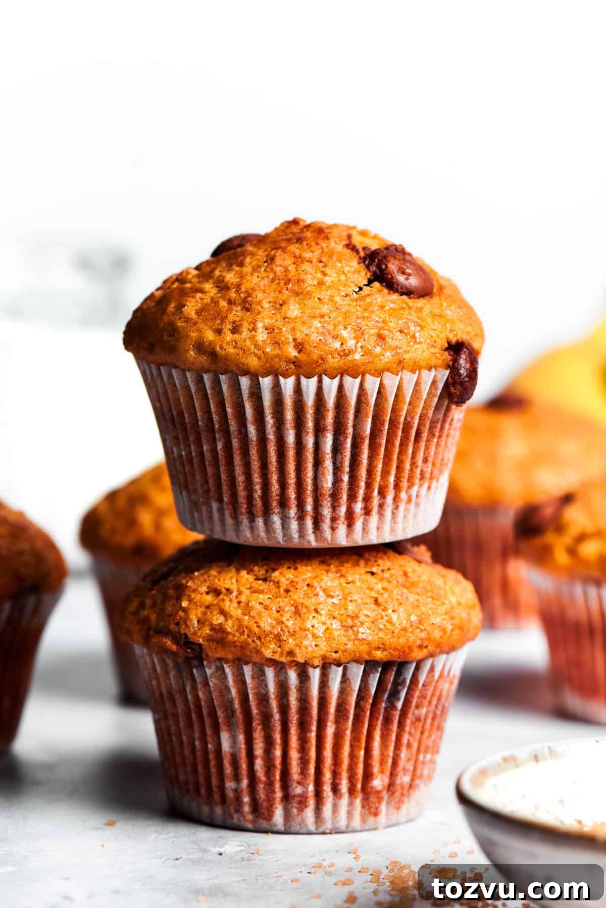 Two banana muffins, one put on top of the other.
