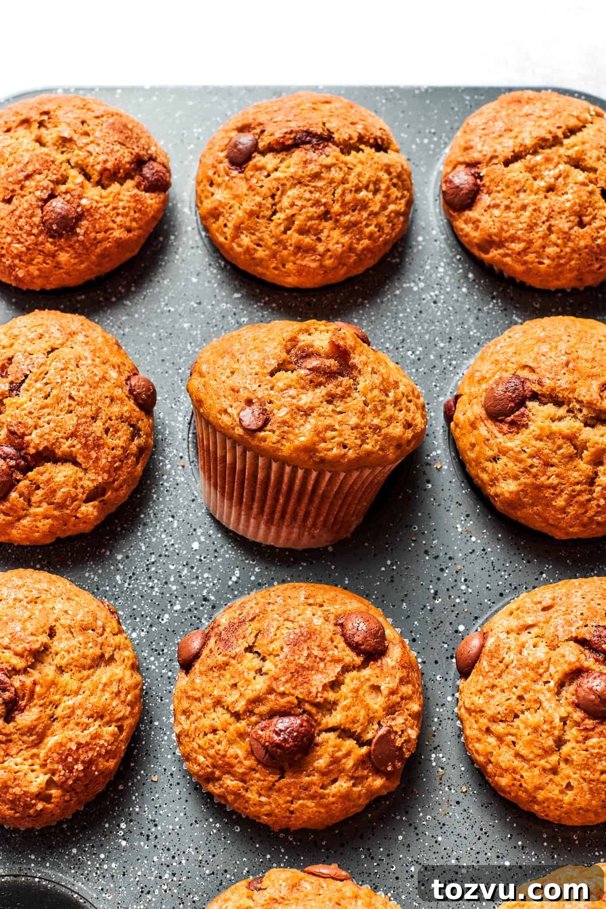Nine banana muffins in a muffin tin.