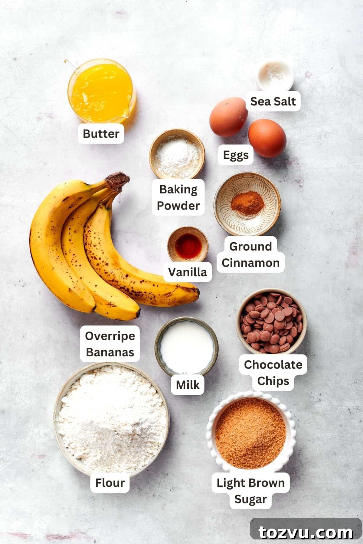 Ingredients for banana muffins recipe: bananas, vanilla, ground cinnamon, butter, baking powder, eggs, sea salt, chocolate chips, flour, brown sugar, milk.