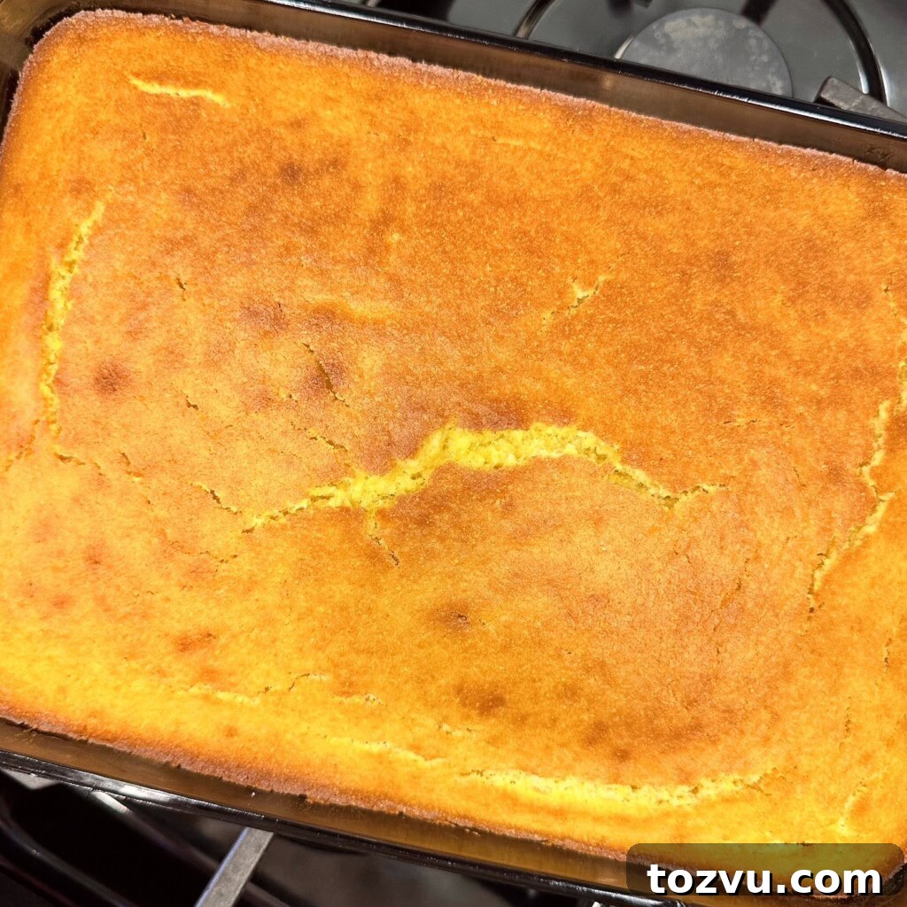 Buttery Sweet Cornbread with Golden Crust 9 Baked cornbread cooling on stove top.