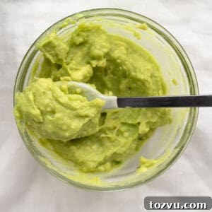 How to Make Avocado Puree for Baby Food 9 avocado puree in a glass bowl with a spoon