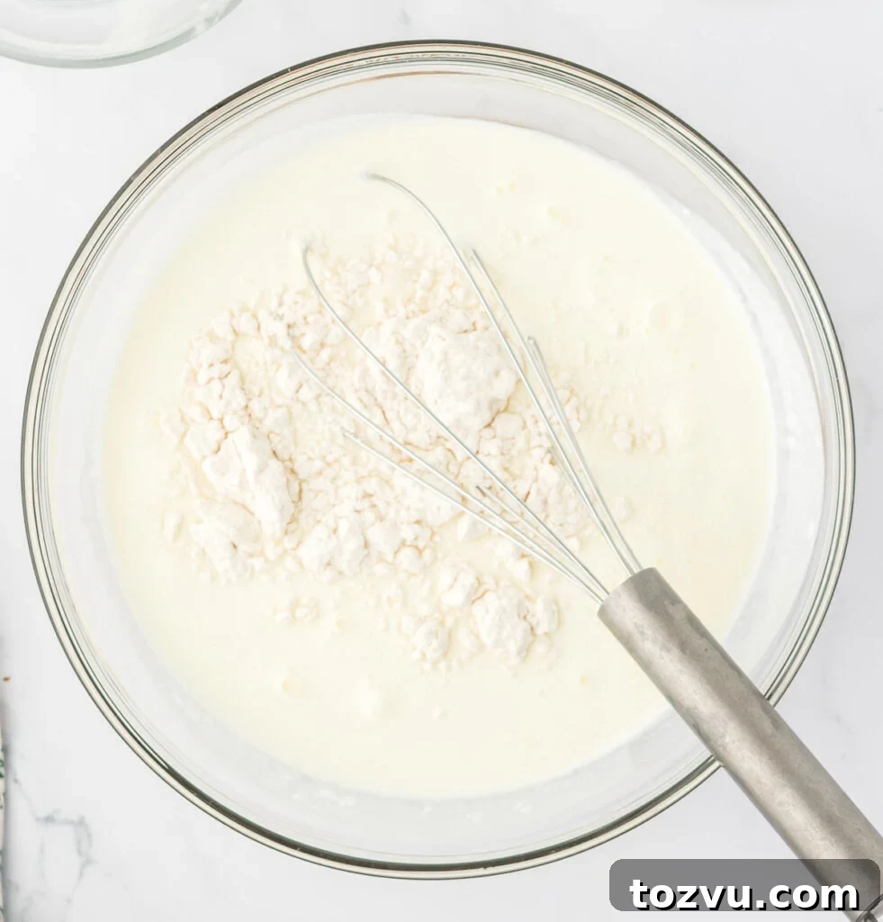 milk, heavy cream, and flour in a bowl