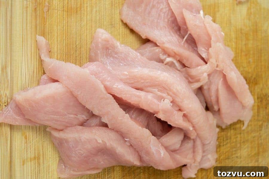 Mole-Spiced Turkey Jerky Recipe 4 Turkey breast sliced for jerky on cutting board