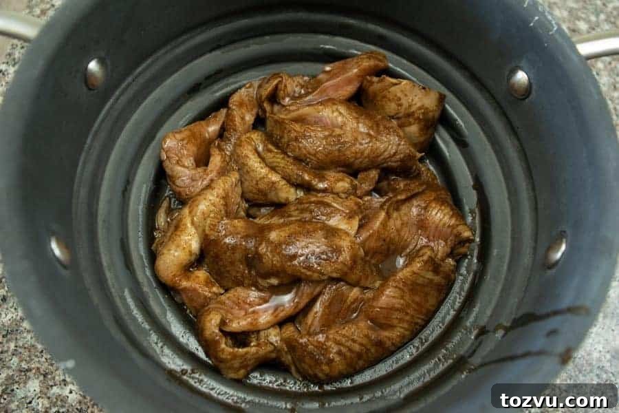 Mole-Spiced Turkey Jerky Recipe 6 mole turkey jerky straining in colander