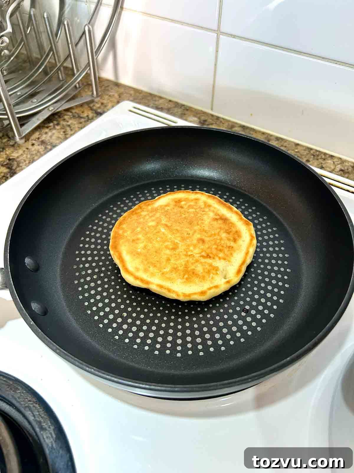 Fluffy Dairy-Free Pancakes Without Milk 8 pancake in skillet after flipping.