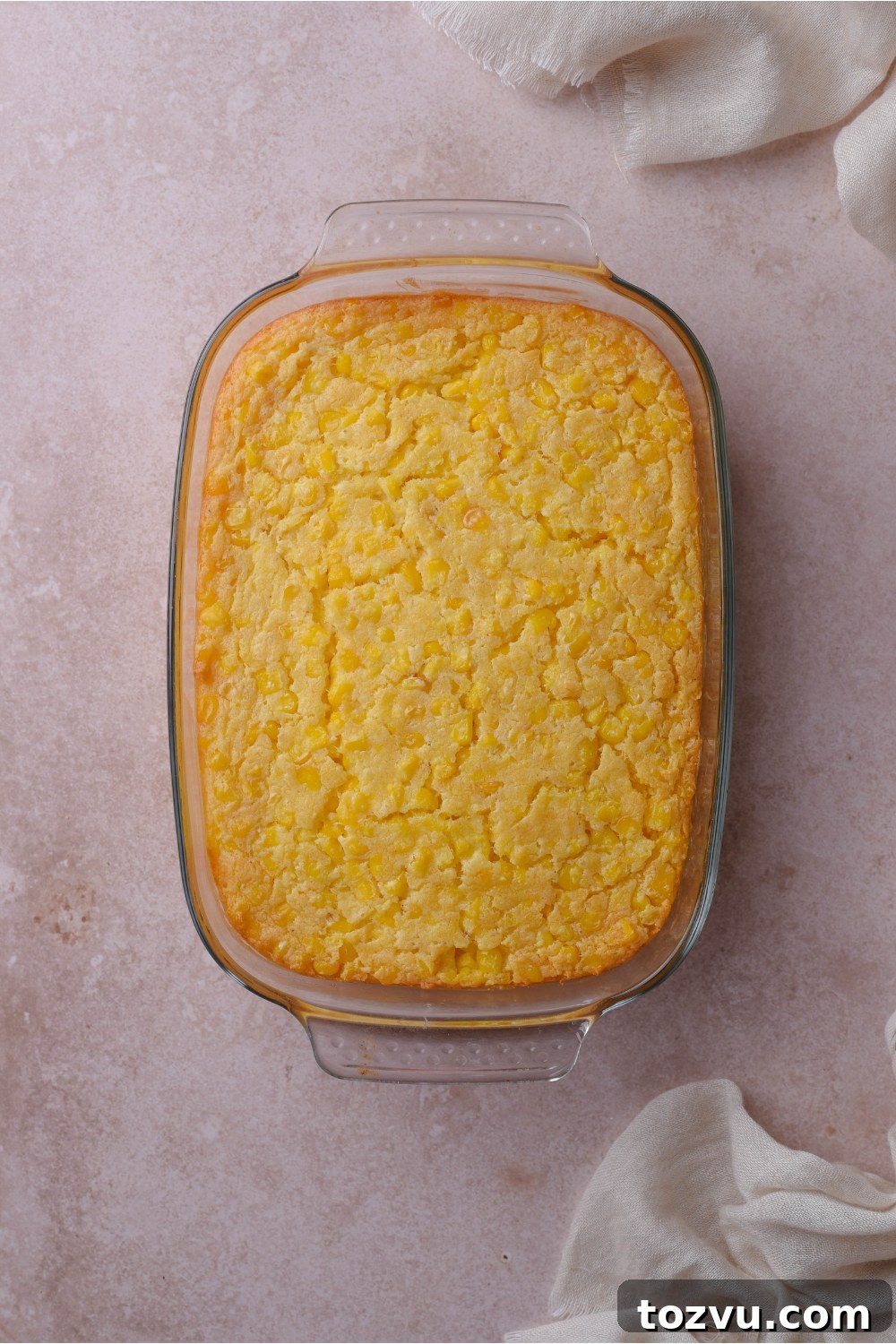 A baking dish filled with freshly baked corn casserole.