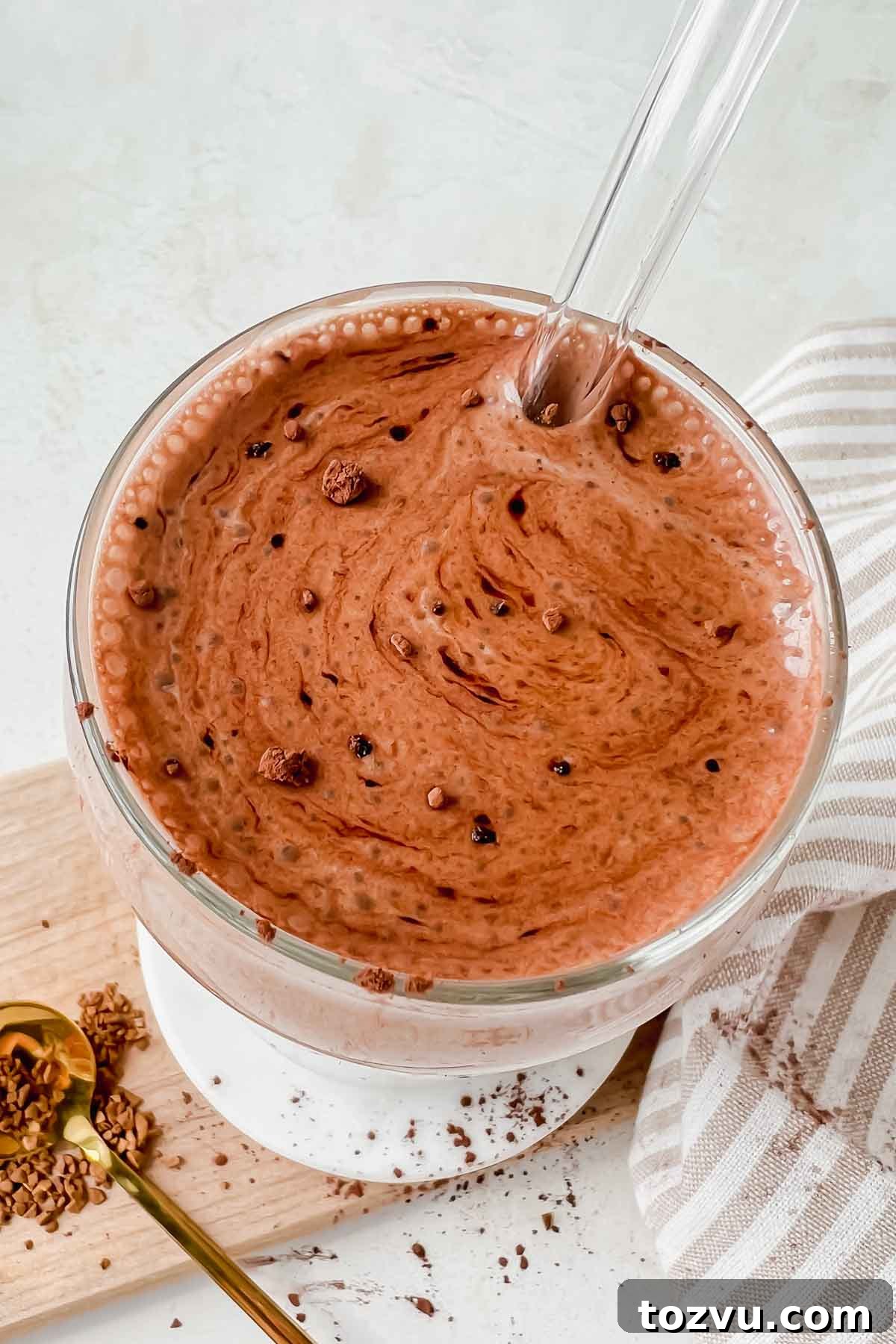 Mocha Madness Smoothie Recipe: Tropical Smoothie Copycat 8 mocha madness smoothie in clear glass, dusted with cocoa powder with glass straw.