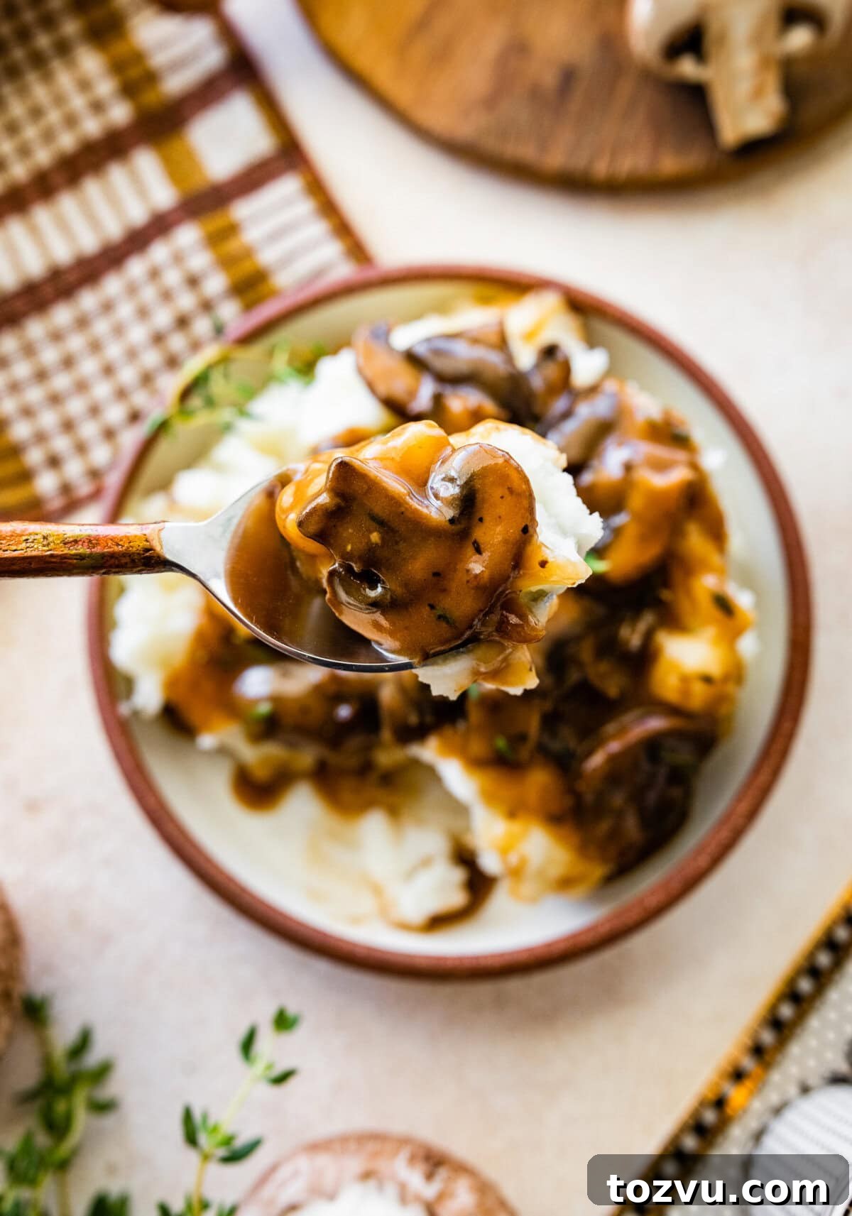How to Make Mushroom Gravy from Scratch 15 Easy mushroom gravy served over mashed potatoes. Spoon holding up a bite.