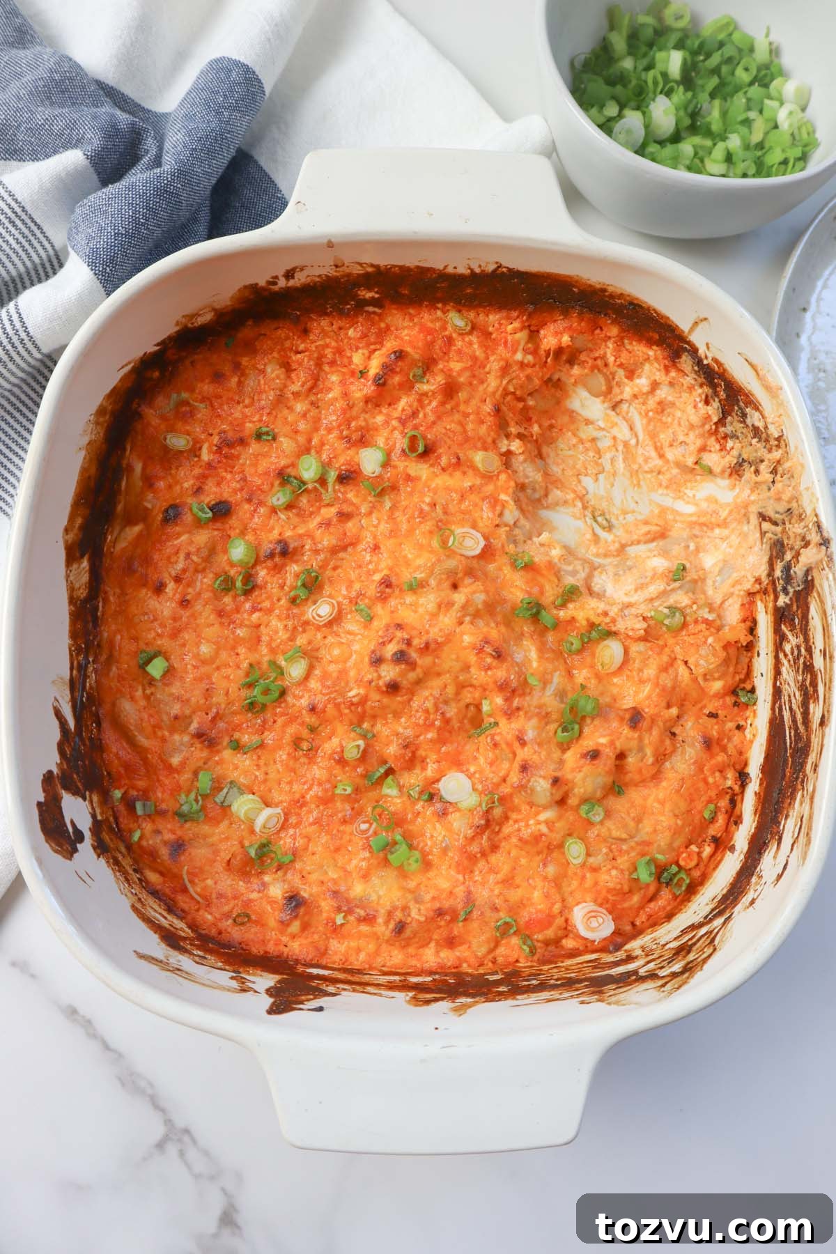 white glass dish with buffalo white bean dip