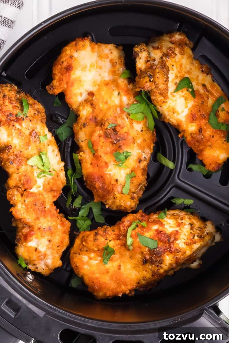 Crispy Air Fryer Chicken Tenders Without Breading 2 Air fryer chicken tenders in basket from air fryer.