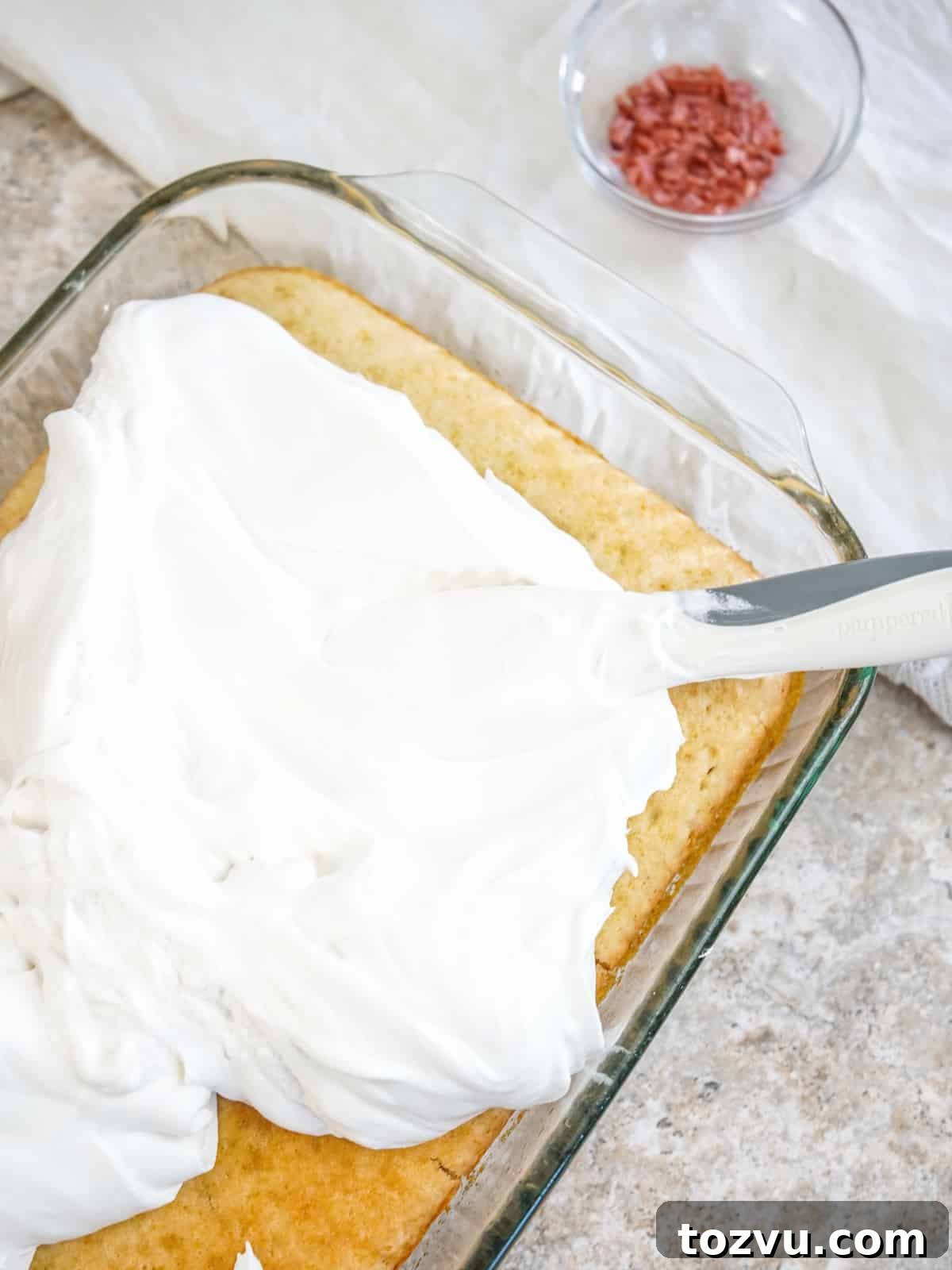 3-Ingredient Cream Soda Cake 7 spread whipped topping on cake