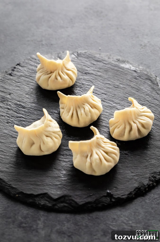 shaped momos arranged on a black board