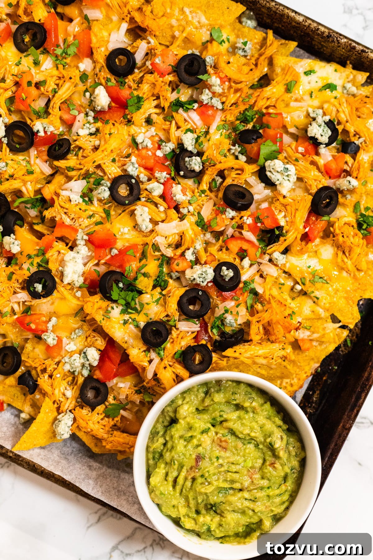 Loaded Buffalo Chicken Nachos with Creamy Ranch Drizzle 2 Sheet pan with cheesy Buffalo chicken nachos