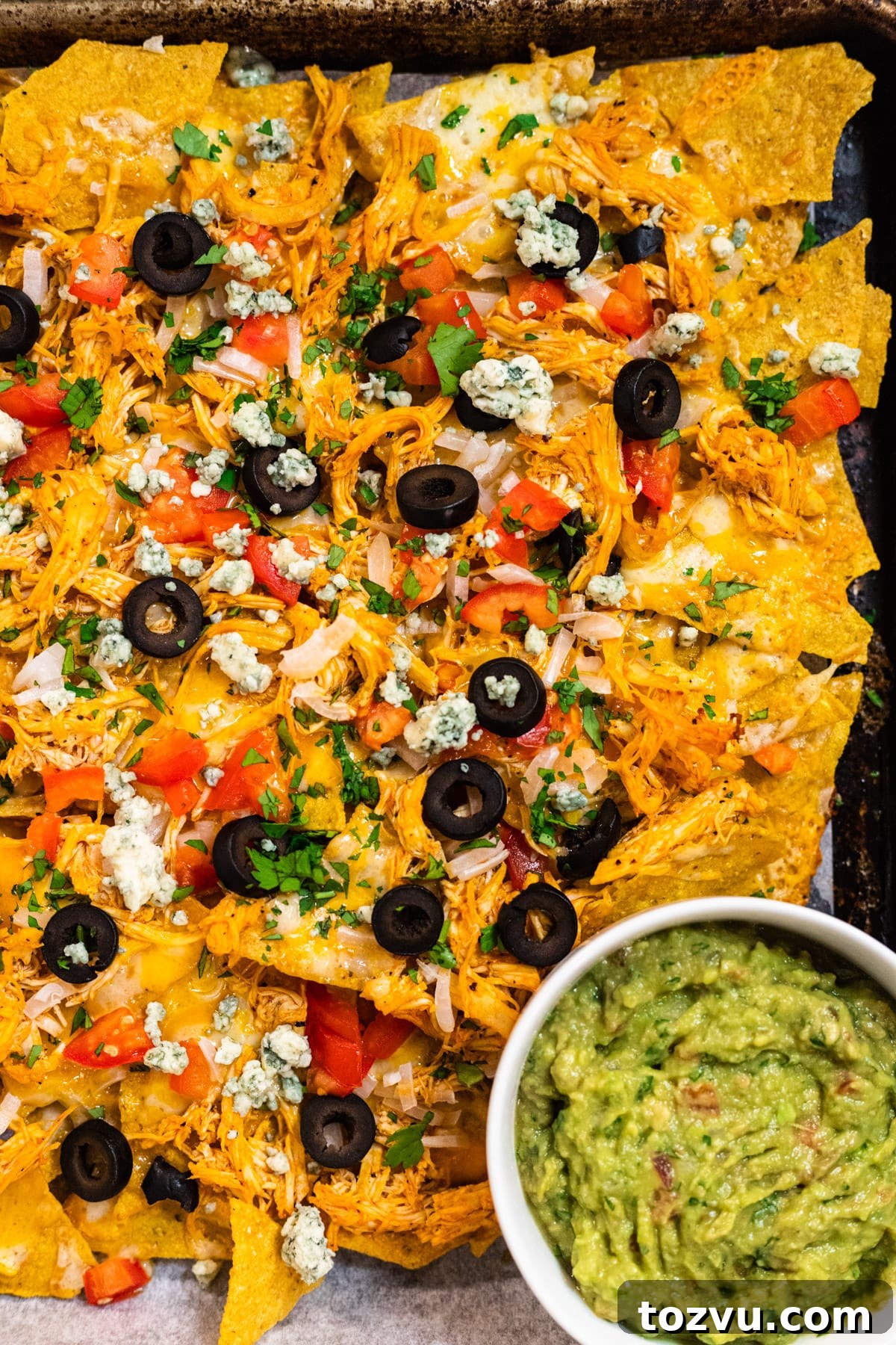 Loaded Buffalo Chicken Nachos with Creamy Ranch Drizzle 7 Finished Buffalo chicken nachos with garnishes