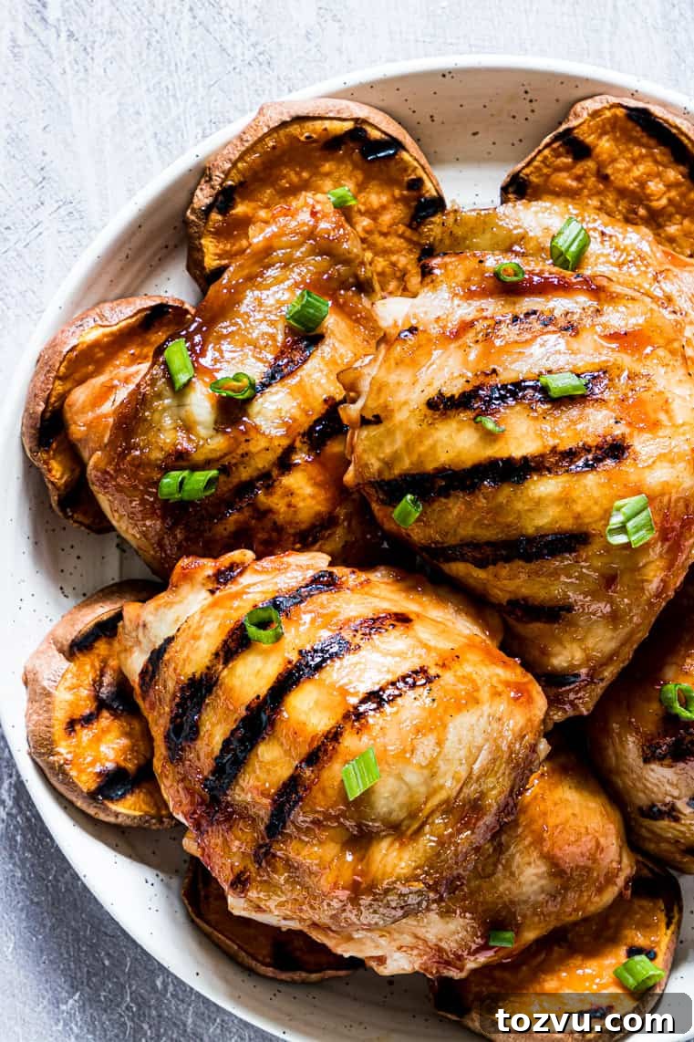 How to Grill Chicken Thighs for Juicy, Crispy Results 3 close up view of grilled chicken thighs with honey barbecue sauce