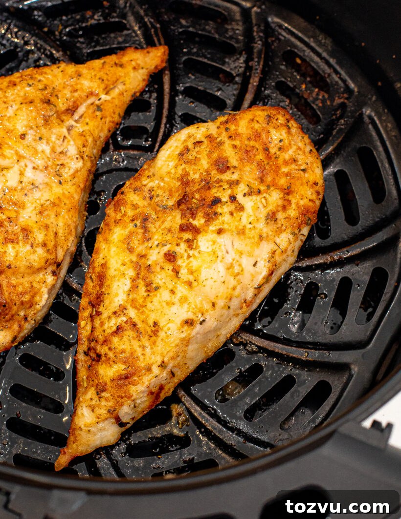 Juicy Air Fryer Chicken Breast Recipe 3 Overhead shot of air fryer chicken in the air fryer basket.