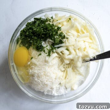 Creamy Ricotta Filling Recipe for Cakes, Cannoli and Pastries 4 A bowl with ricotta, eggs, mozzarella, parsley, and parmesan cheese.
