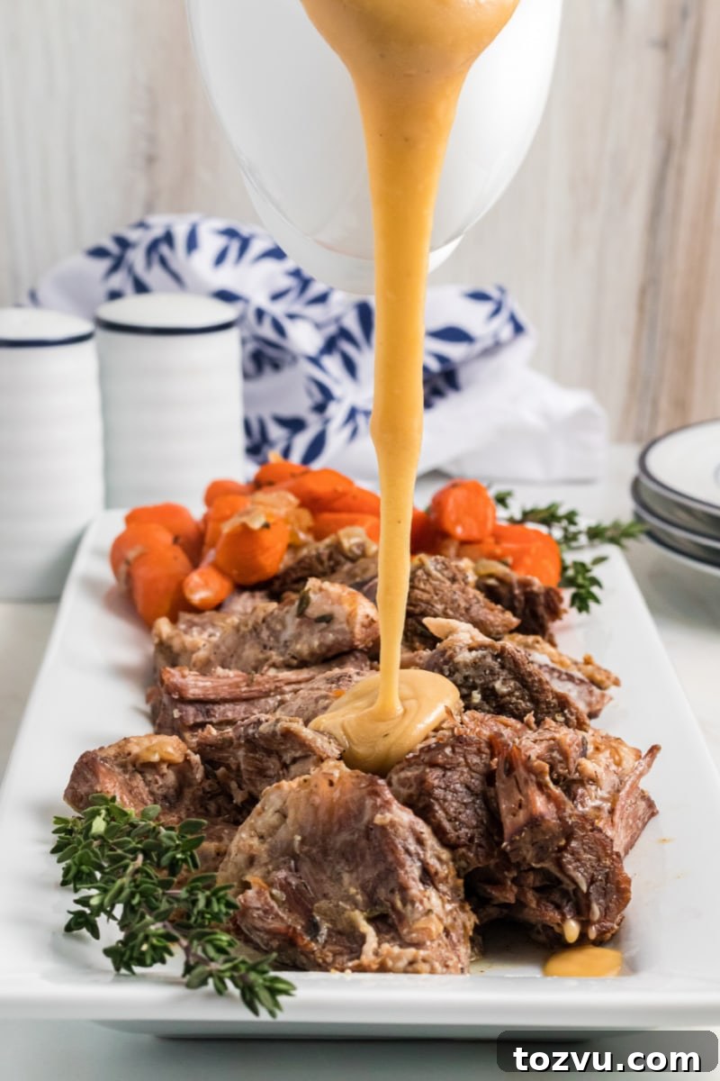 pouring gravy onto pot roast on a platter