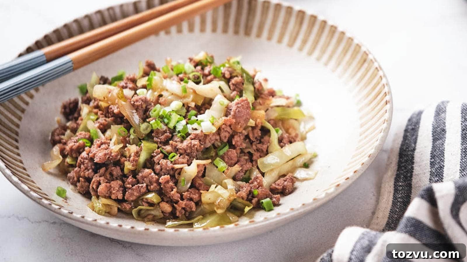 17 Thanksgiving Recipes Ready in Minutes 13 Ground beef and cabbage stir fry being scooped out from a skillet.