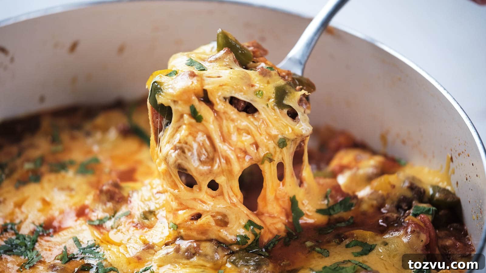 17 Thanksgiving Recipes Ready in Minutes 10 A close-up of ground beef taco skillet being served with a metal spoon.