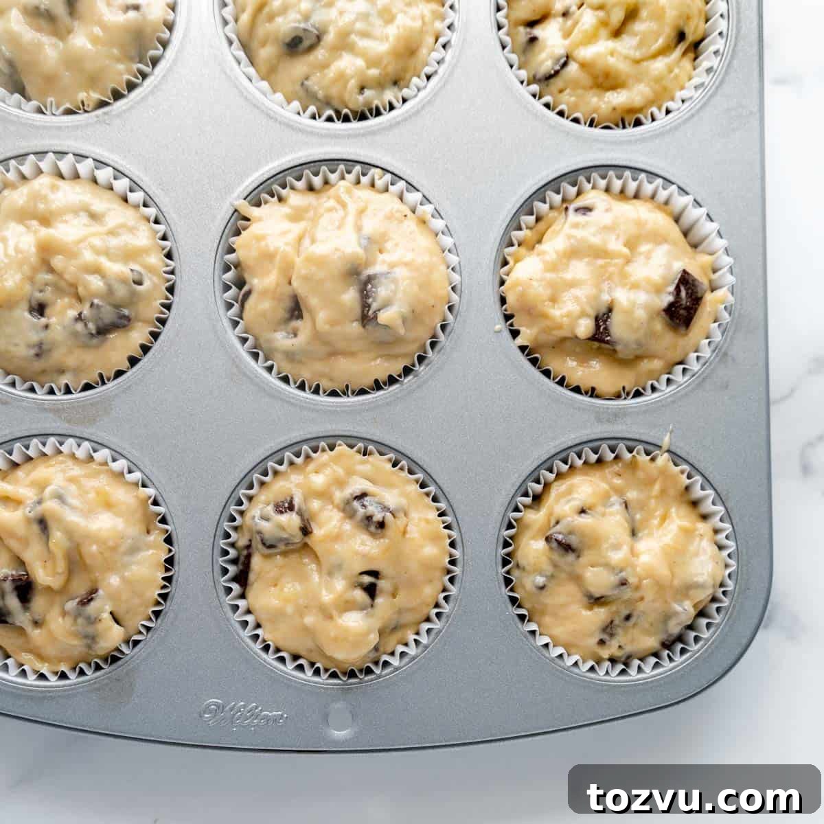Muffin batter in a muffin pan.