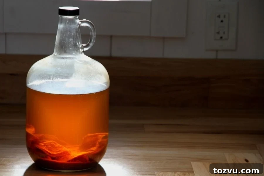 How to Make Apple Cider Vinegar from Scratch 2 A jug of apple cider vinegar with a mother culture in the bottom