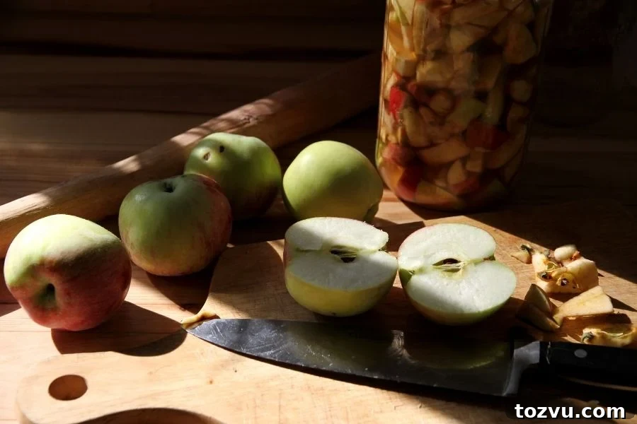 How to Make Apple Cider Vinegar from Scratch 3 apples being chopped on a cutting board