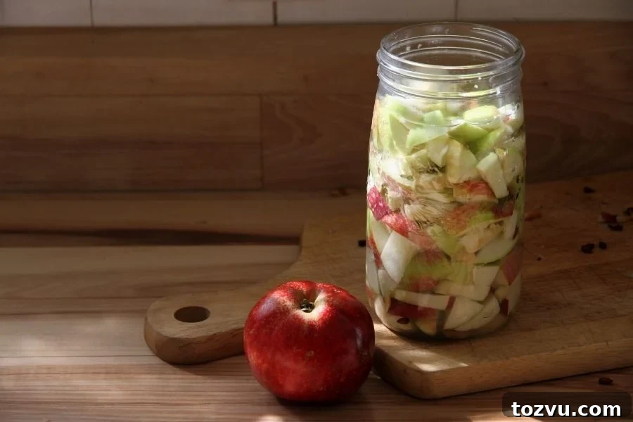 How to Make Apple Cider Vinegar from Scratch 5 a glass jar filled with dice apples for making homemade vinegar