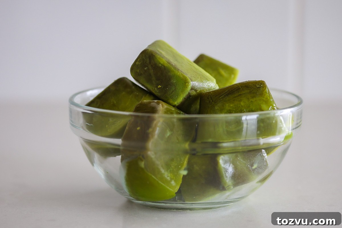 Matcha Ice Cubes for Iced Lattes, Smoothies and Cold Brew 7 Matcha ice cubes in a glass bowl.