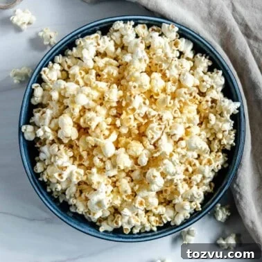 finished Sweet and Salty Popcorn in a blue bowl against a white background