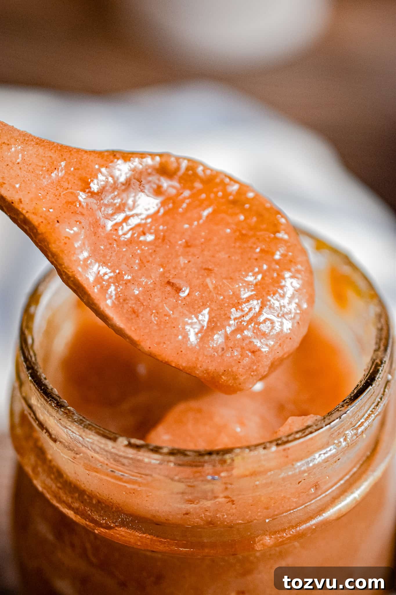 Quick Instant Pot Pear Butter Recipe 8 A spoon lifting the Instant Pot pear butter out of the jar.