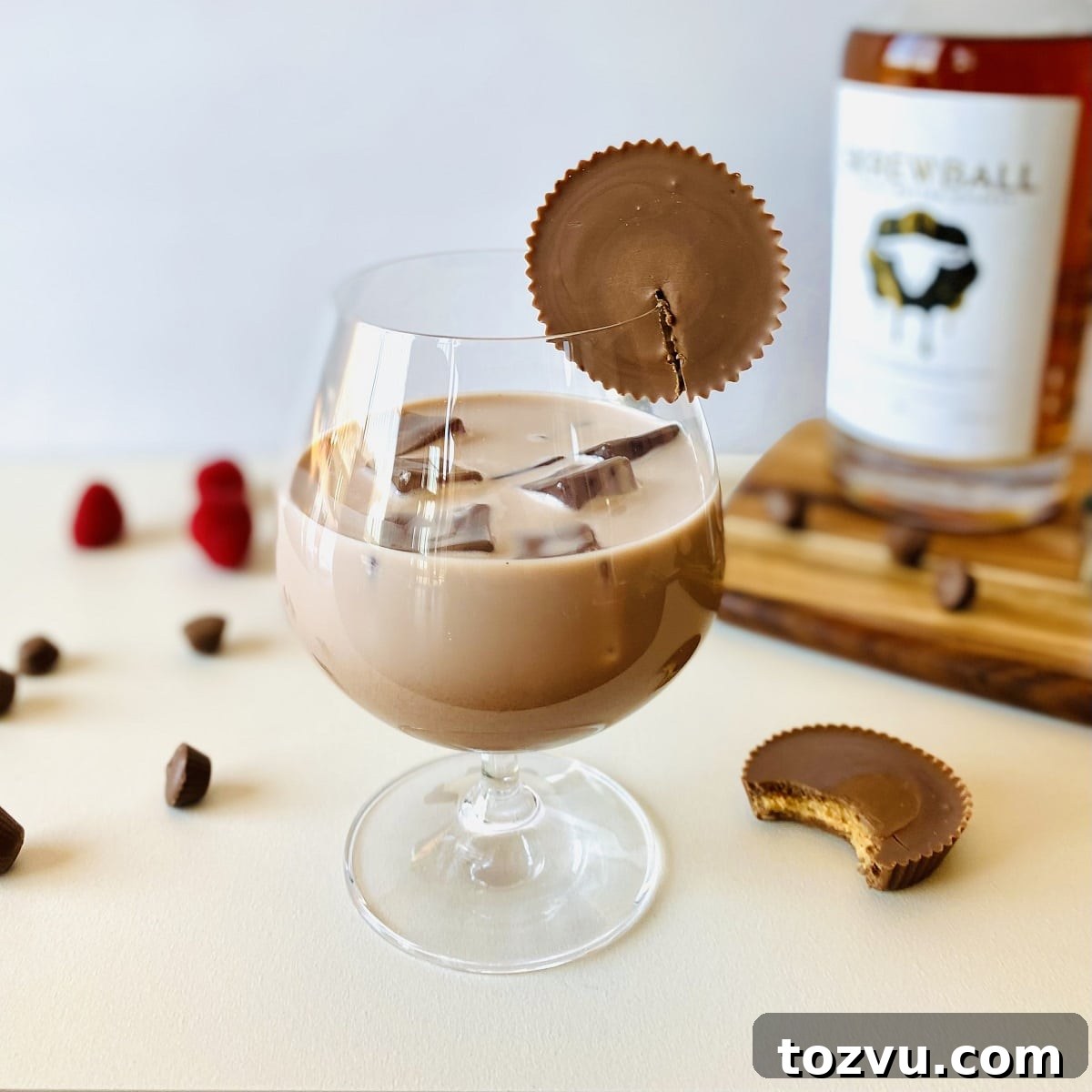 Peanut Butter Whiskey: Brands, Recipes & Cocktail Ideas 3 peanut butter whiskey drink with peanut butter cup on rim and skrewball whiskey in background
